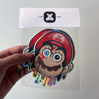 a hand holding an Ayecon Mario and David Bowie mashup three pack in packaging