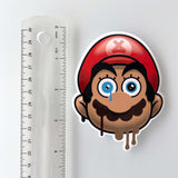 Mario by the Ayecon street sticker slap next to a ruler showing a height of roughy 3.5 inches